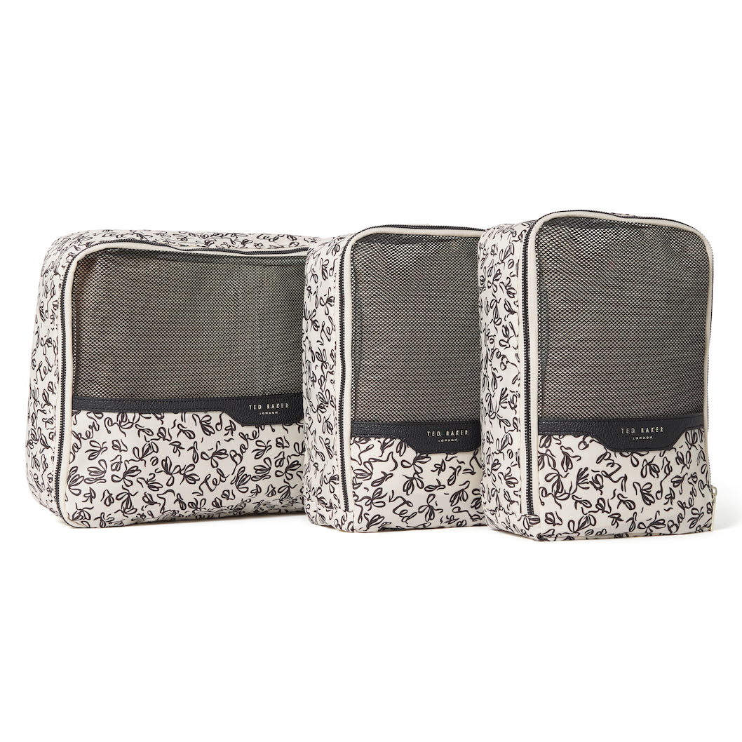 Set of three Ted Baker ribbon-patterned packing cubes with mesh and PU finishes and Ted Baker branding on a white background