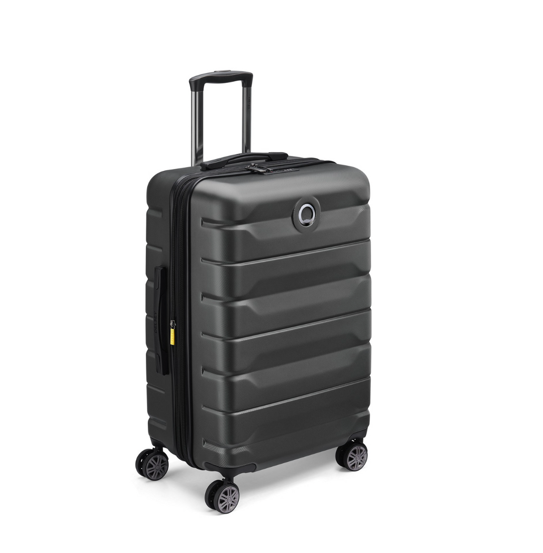 Black Delsey suitcase with wheels on a white background