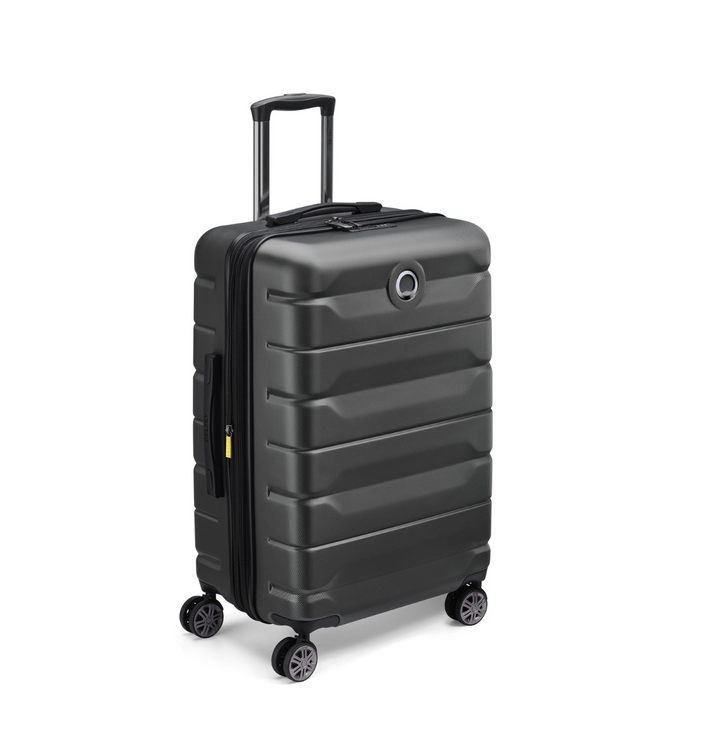 Black Delsey suitcase with wheels on a white background