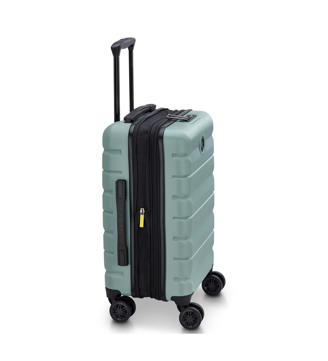 Side angle of a Sage Green Delsey suitcase with expandability, black wheels and handle on a white background
