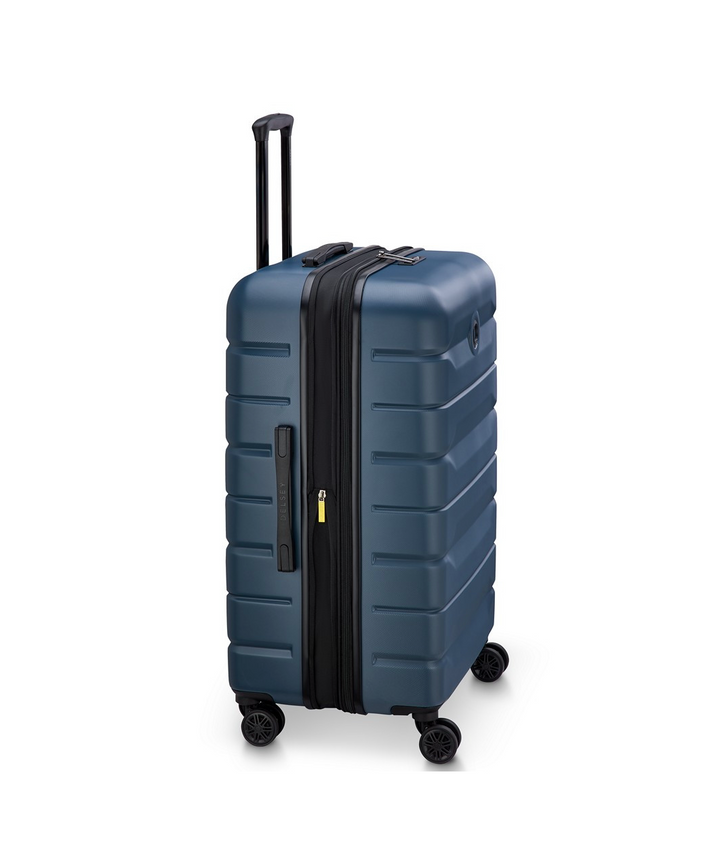 Side angle of a blue suitcase with black handle and wheels on a white background