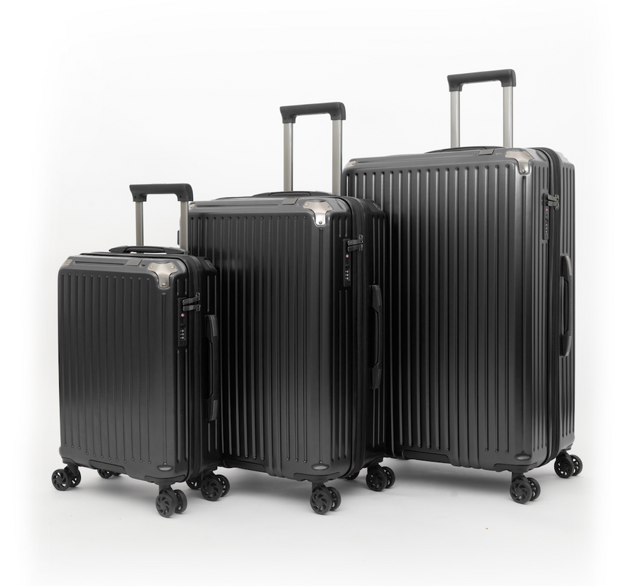 Three hard-shell spinner suitcases in black, shown in a size progression from smallest to largest on a clean white studio background.