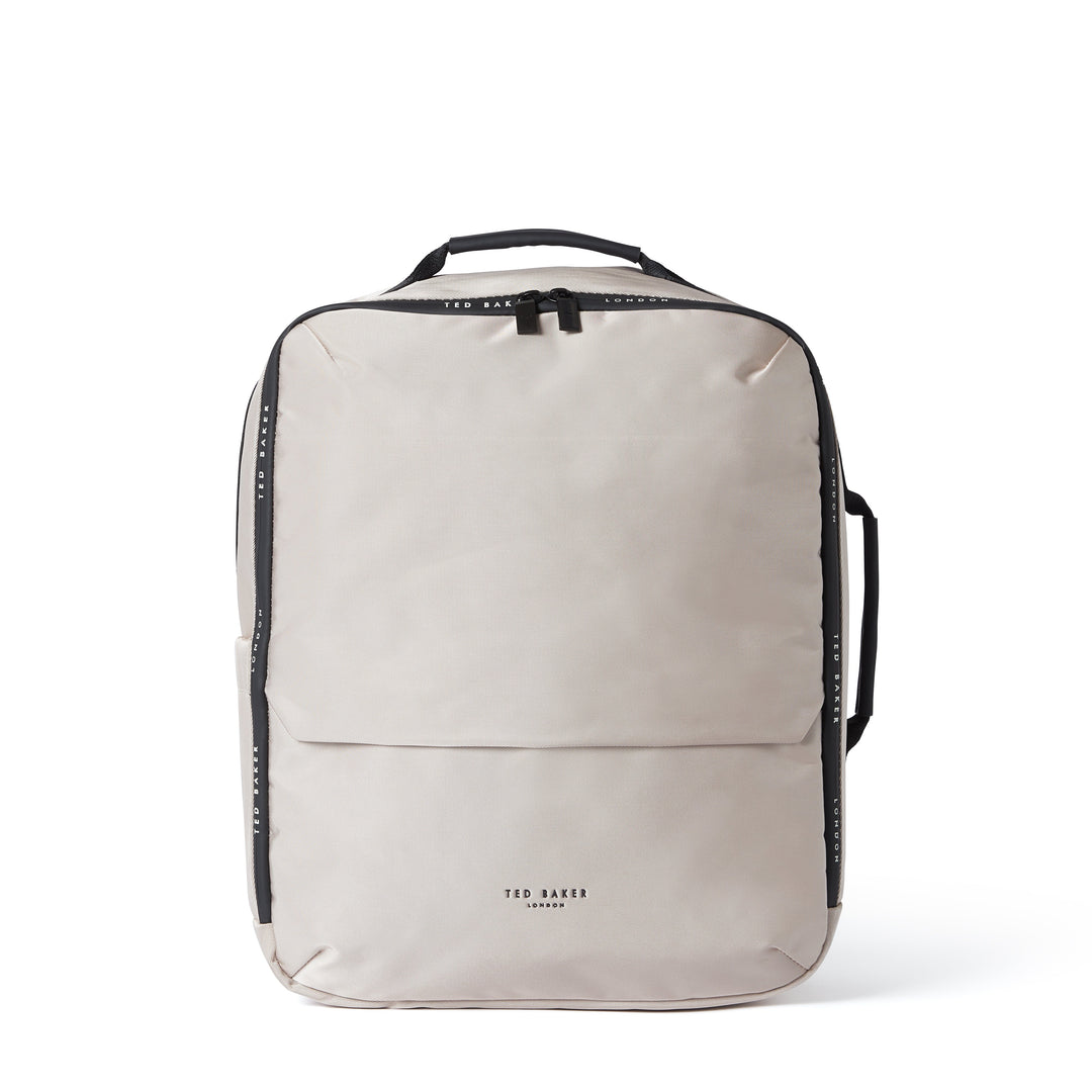 A light beige Ted Baker backpack with black trim, side handles, and a top handle, shown against a plain white background.