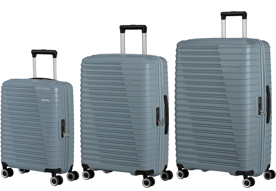 Three slate blue American Tourister suitcases of different sizes on a white background 