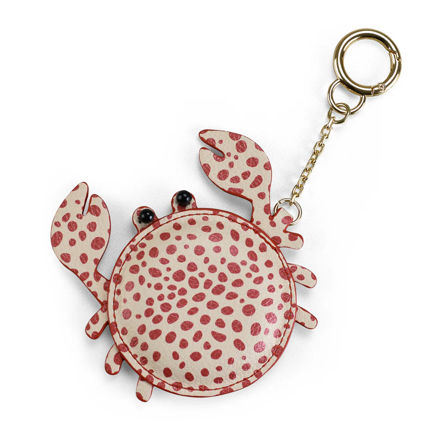 Crab-shaped keychain with red spots on a white background