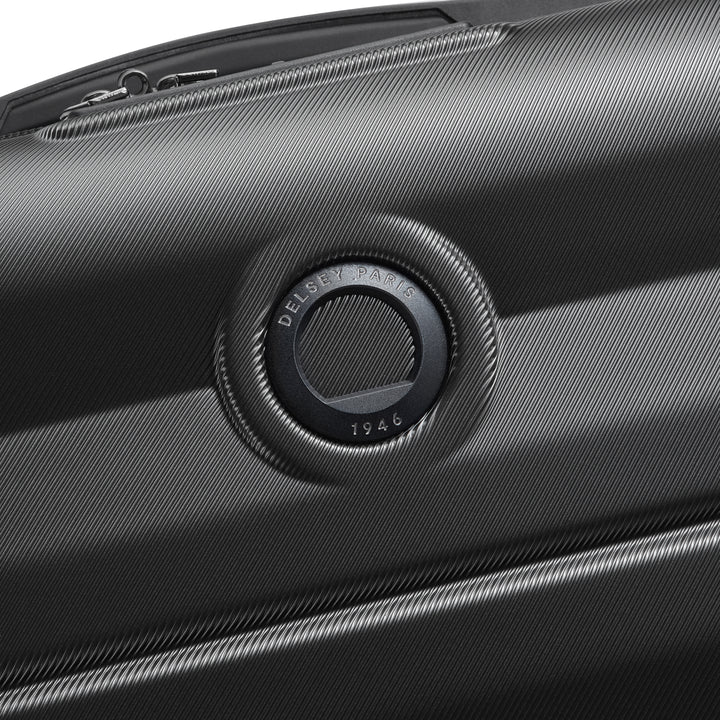 Close-up of a black suitcase with Delsey brand logo on a white background