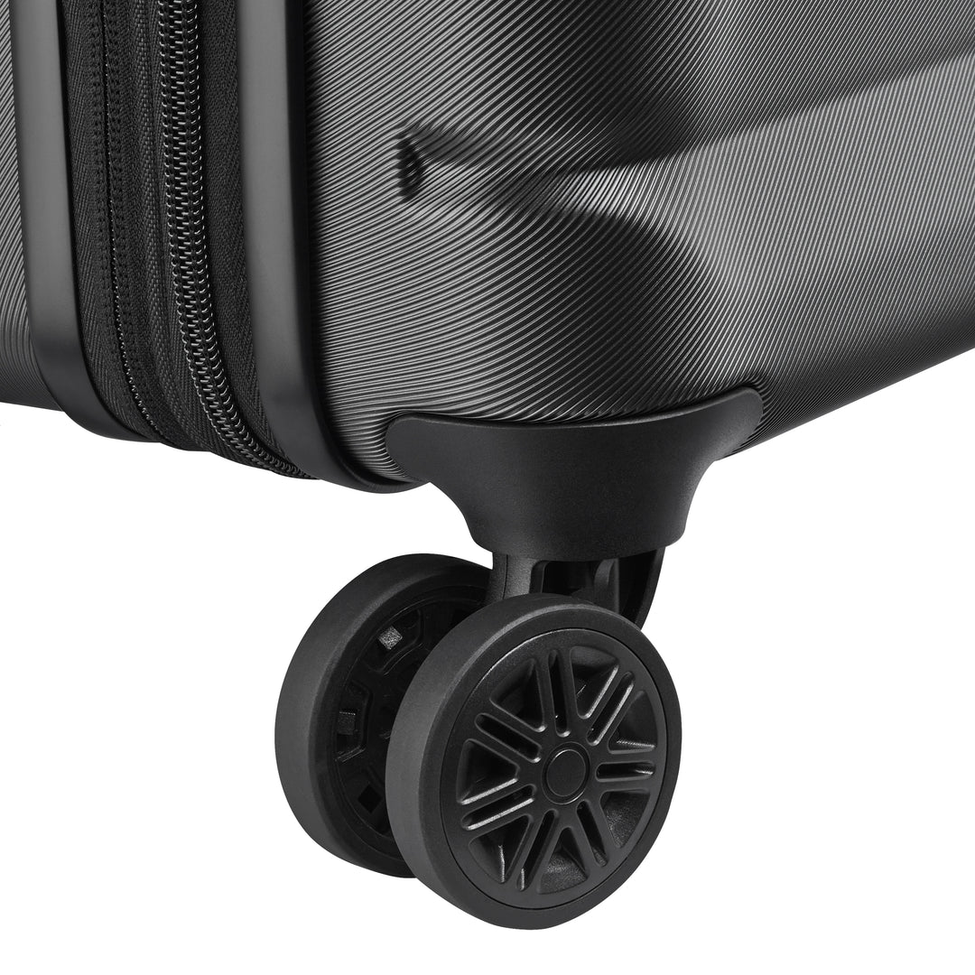 Close-up of a black suitcase wheel on a white background