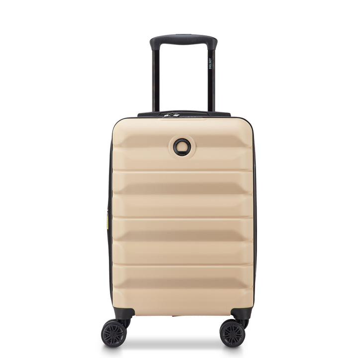 Beige Delsey suitcase with black handle and wheels on a white background