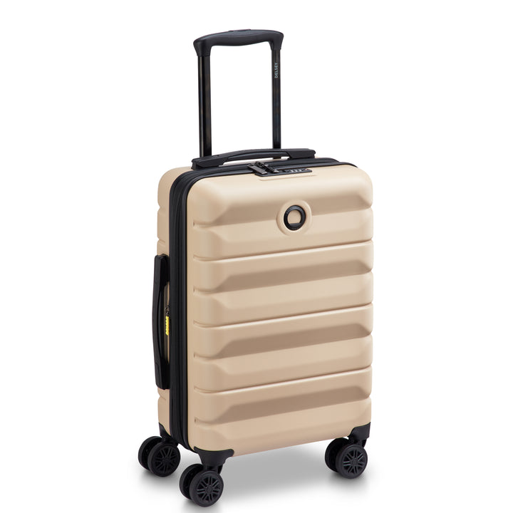 Beige Delsey suitcase with black handle and wheels on a white background