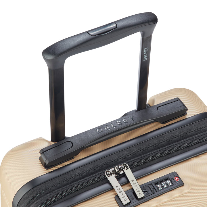 Close-up top view of a beige suitcase with black handle and zipper, featuring Delsey branding.
