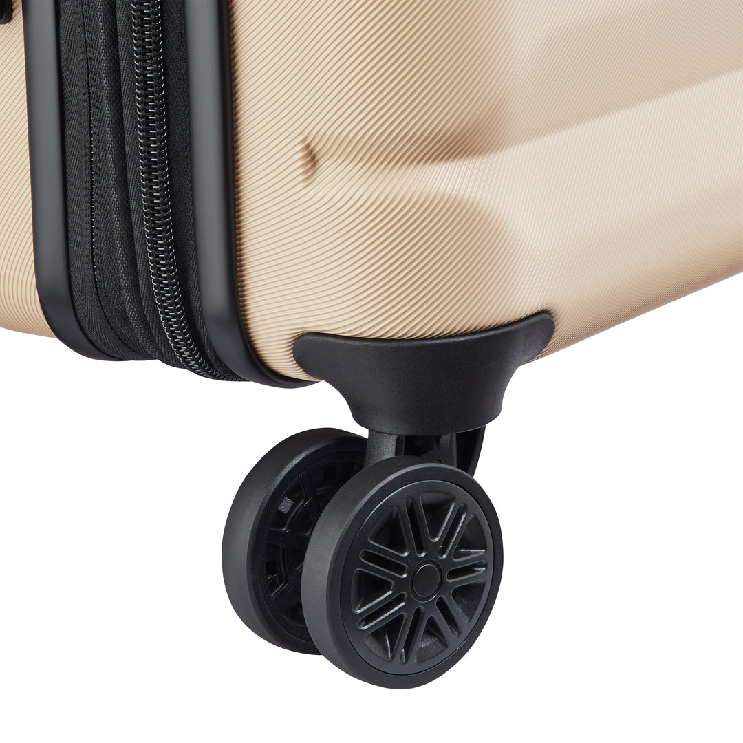 Close-up of a beige suitcase with a black wheel on a white background