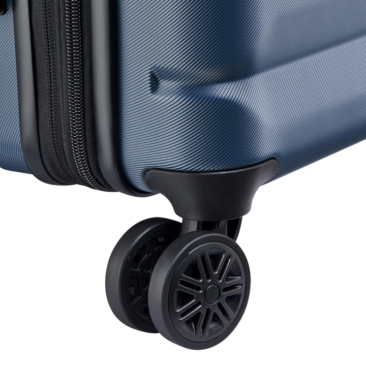 Close-up of a blue suitcase with a black wheel on a white background