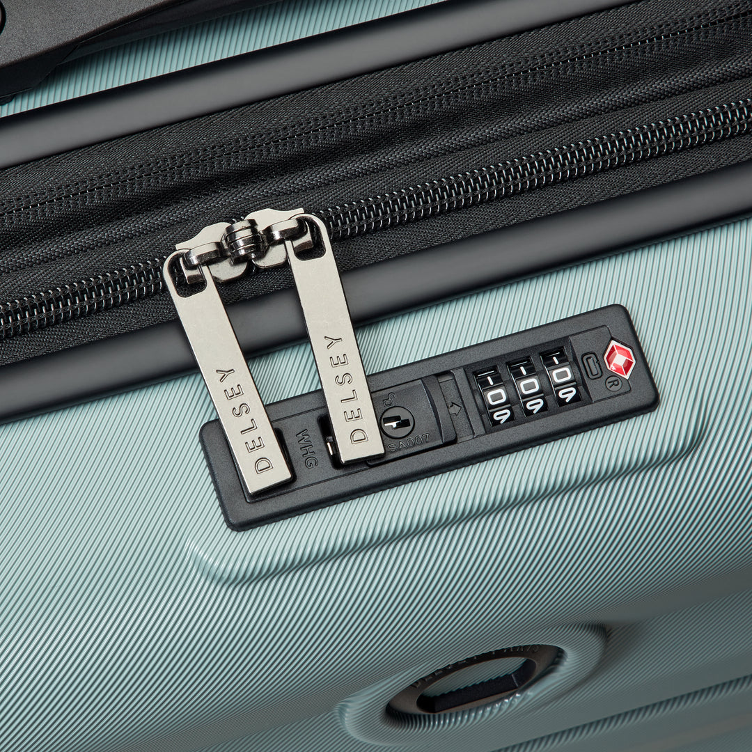 Close-up of a suitcase with a security lock and Delsey branded zip pullers