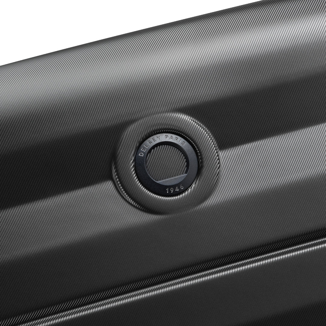 Close-up of a black suitcase Delsey brand logo on a white background