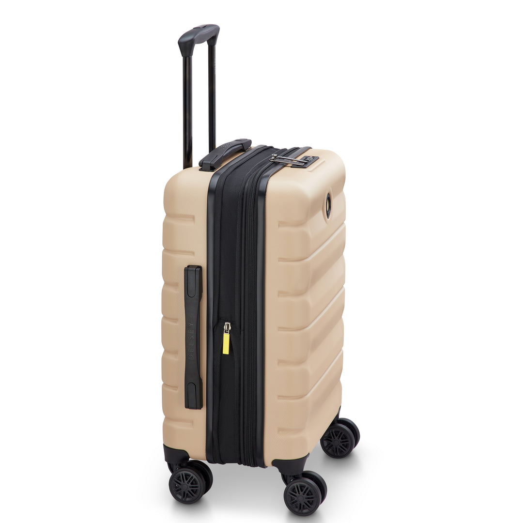 Side angle of a Beige Delsey suitcase with expansion, a black handle and wheels on a white background