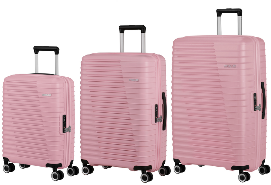Set of three pink suitcases of different sizes on a white background